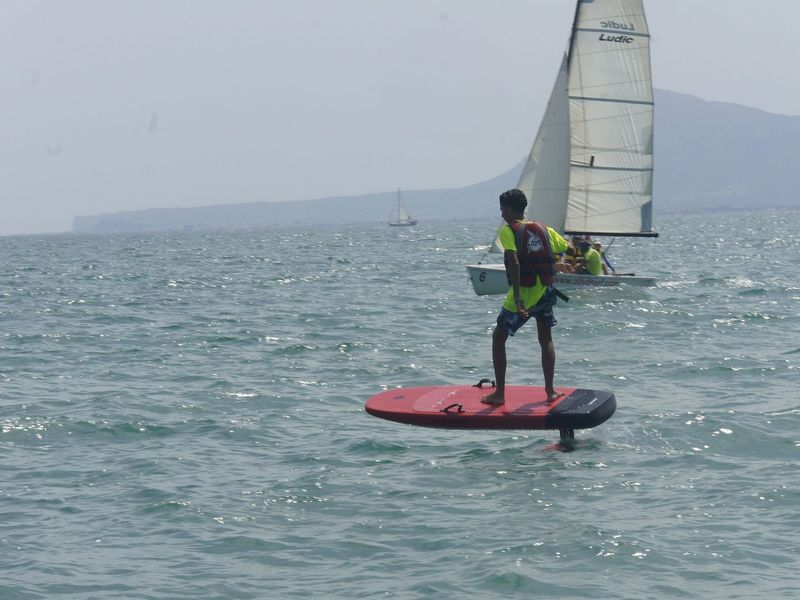eFoil junto a un barco de vela ligera